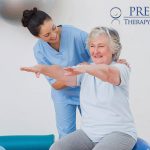 a physical therapist helping an elderly woman stretch