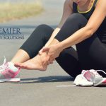 Woman sitting on road, holding her ankle in pain, next to running shoes, Premier Therapy Solutions logo visible.
