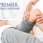 Physical therapist assisting with knee therapy at Premier Therapy Solutions.