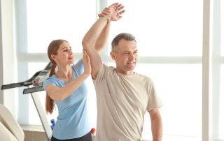 physical therapist working on patients arm