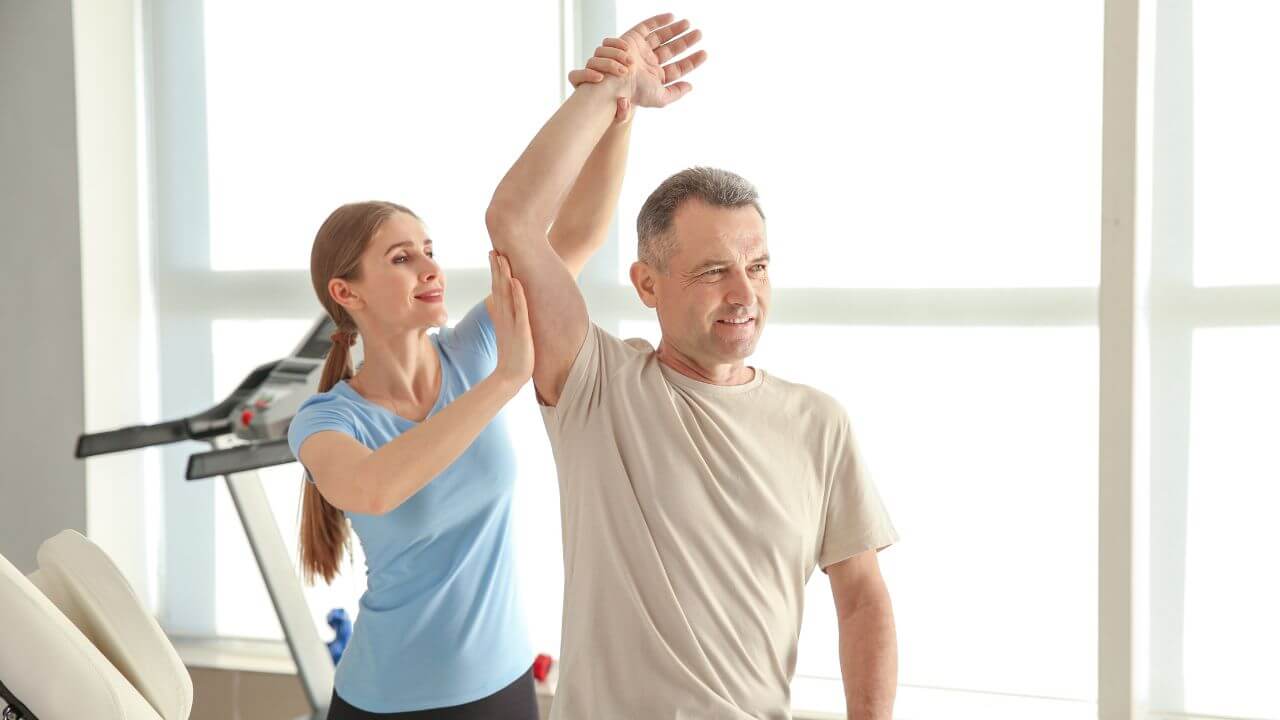 physical therapist working on patients arm