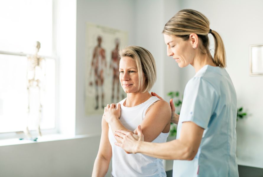 physical therapist working on female patient's arm