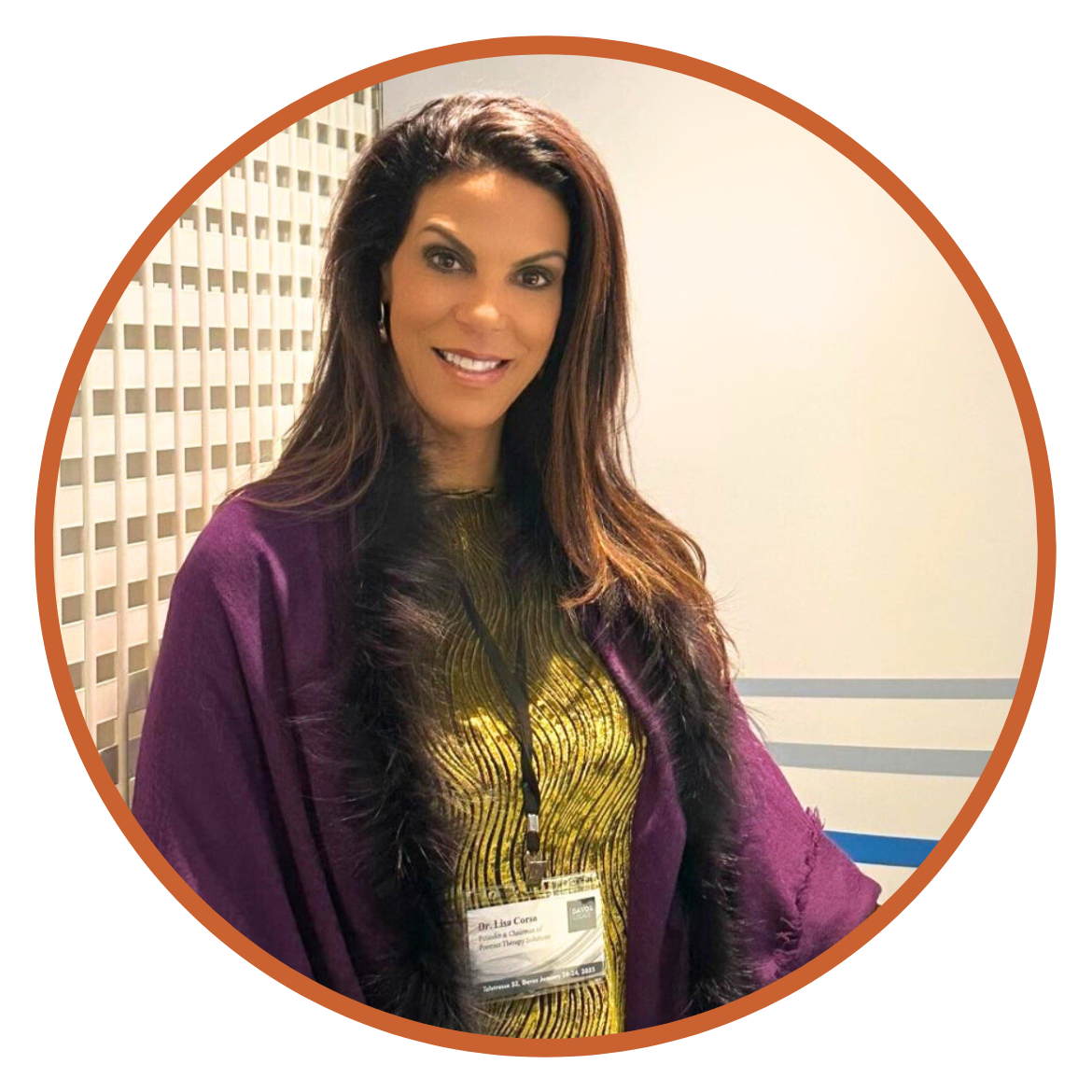 1 I'm not sure who this is, but here's your alt text:Smiling woman in a purple shawl and gold top at a conference.