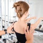 a woman in physical therapy doing back stretches as part of the scroth method for scoliosis