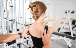 a woman in physical therapy doing back stretches as part of the scroth method for scoliosis