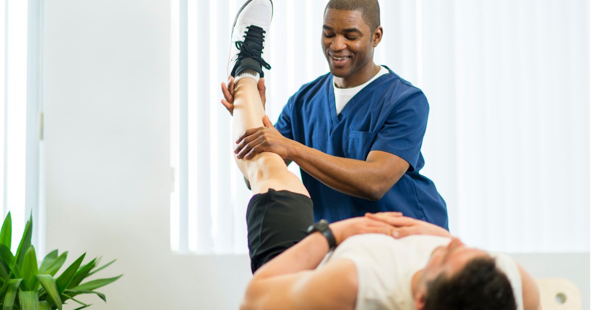 PT for Athletes in Boca Raton - Premier Therapy Boca Raton Physical therapist performing leg mobility exercises with male athlete during rehabilitation