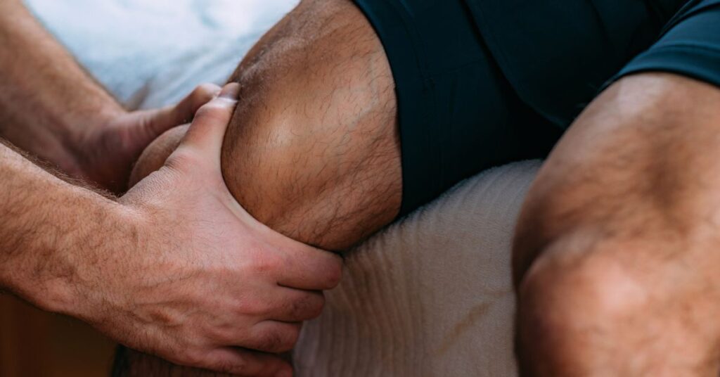 Physical therapist performing knee massage for post surgical rehabilitation
