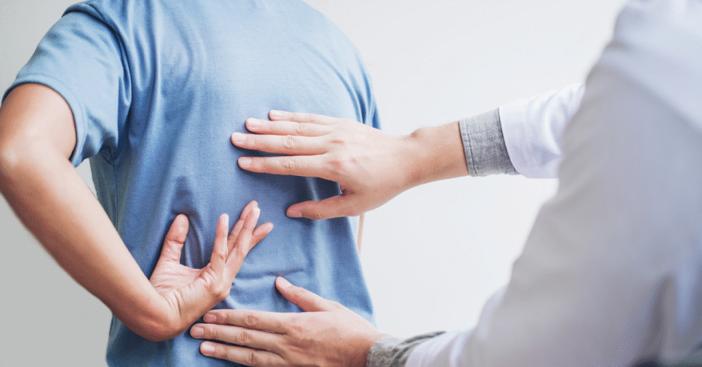 Physical therapist evaluating a patient’s lower back pain at PT VIP Health Boca Raton