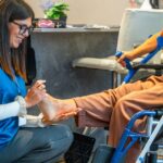 Leg Mobility Assessment in Physiotherapy - Premier Therapy Boca Raton Healthcare professional evaluating a patient’s leg mobility during a physiotherapy session