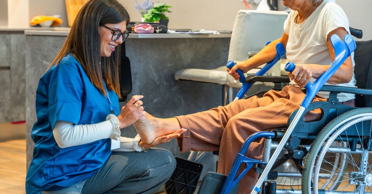 Healthcare professional evaluating a patient’s leg mobility during a physiotherapy session