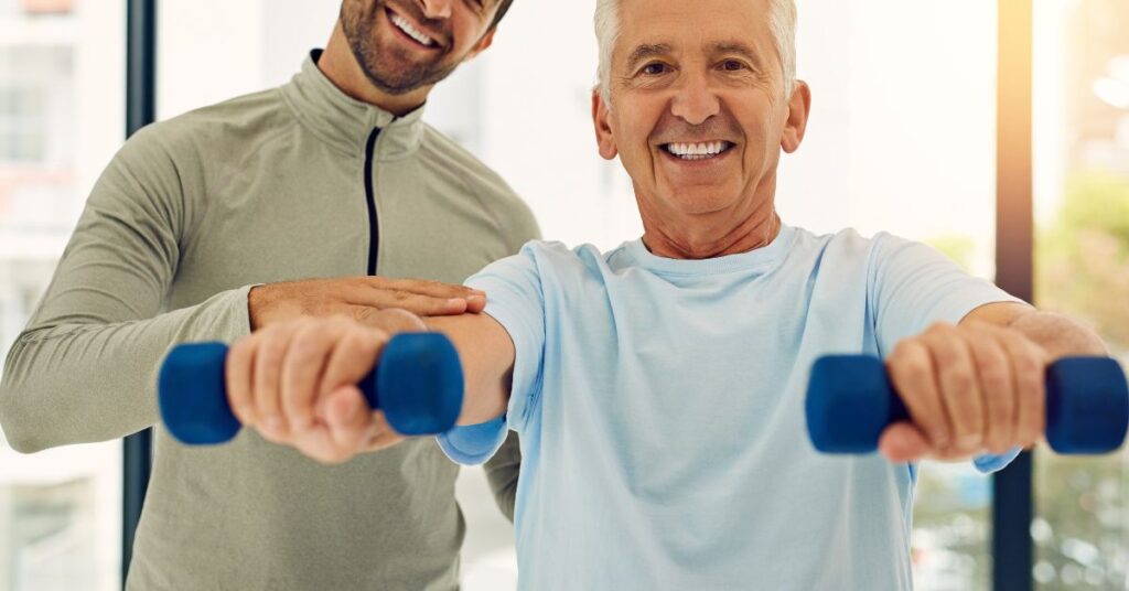 Physiotherapist performing arm mobility training with a patient to improve balance and coordination