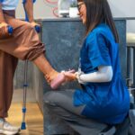 Injury specialist providing hands-on rehabilitation care to help a patient improve mobility and balance