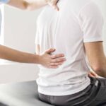 Physical therapist performing manual therapy for chronic back pain to improve mobility and reduce discomfort.