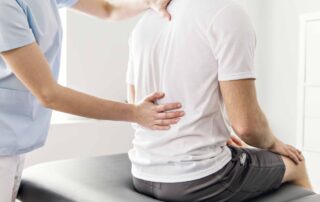 Physical therapist performing manual therapy for chronic back pain to improve mobility and reduce discomfort.