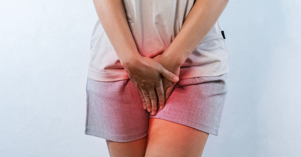 A woman holding her lower abdomen and pelvic area with a red glowing overlay representing localized pain, inflammation, or discomfort.